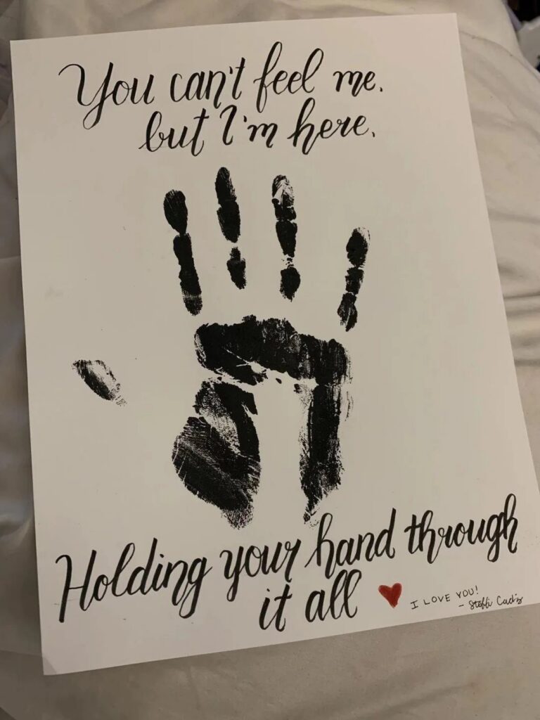 Handprint art on white paper with romantic cursive text and a red heart.