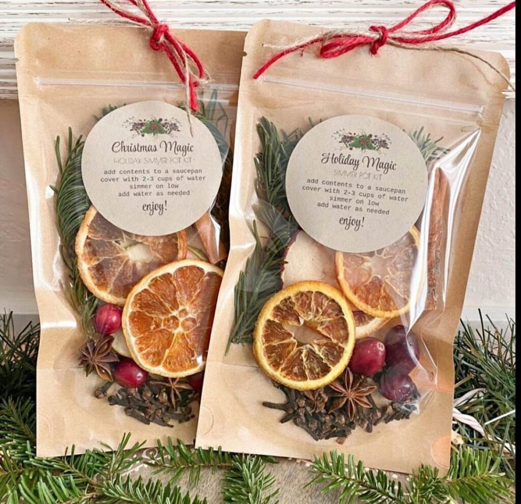 Two brown paper pouches filled with dried citrus and spices for holiday potpourri.