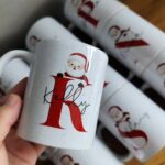 White ceramic mug with a red letter K, name Kelly, and Santa Claus