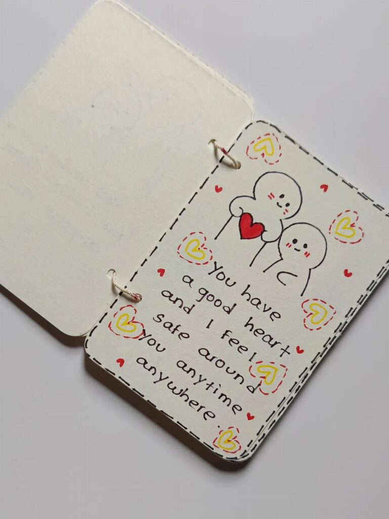 Handmade romantic card with cute character drawings and a heartfelt handwritten message.