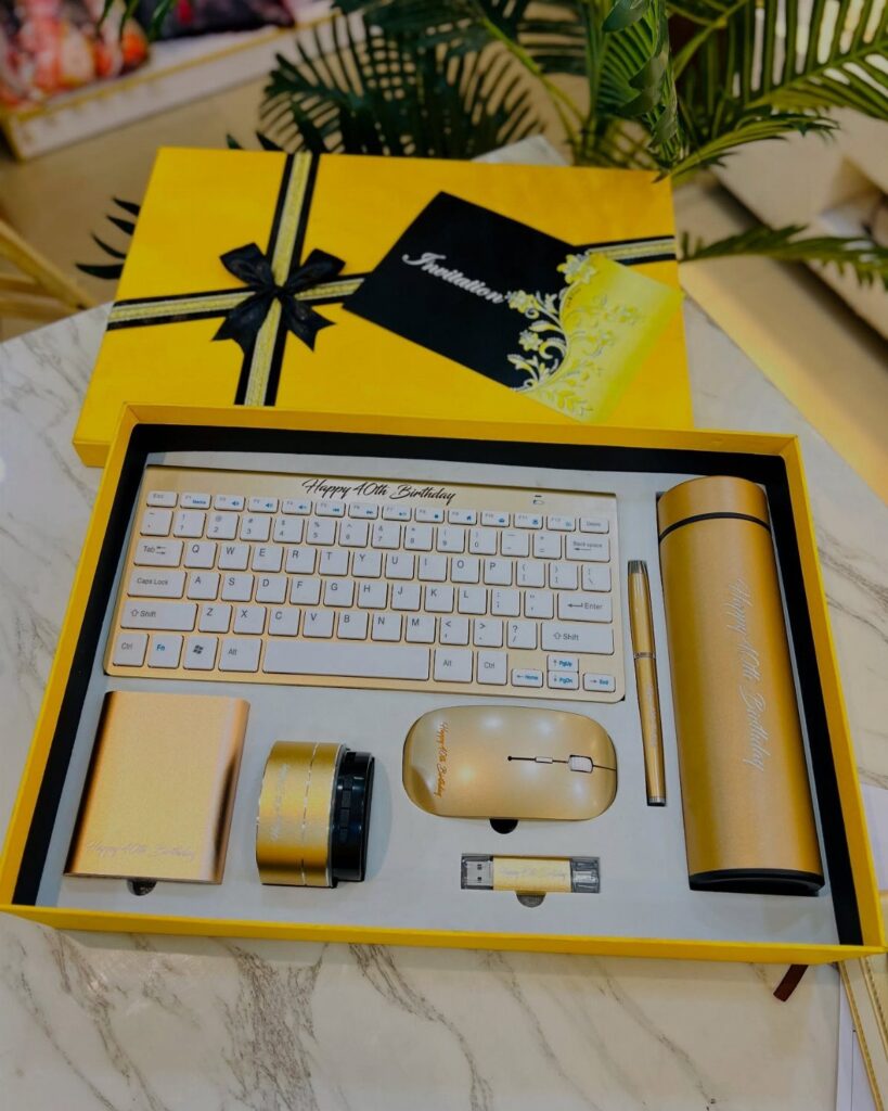 Gold birthday gift set with keyboard and accessories in a yellow box