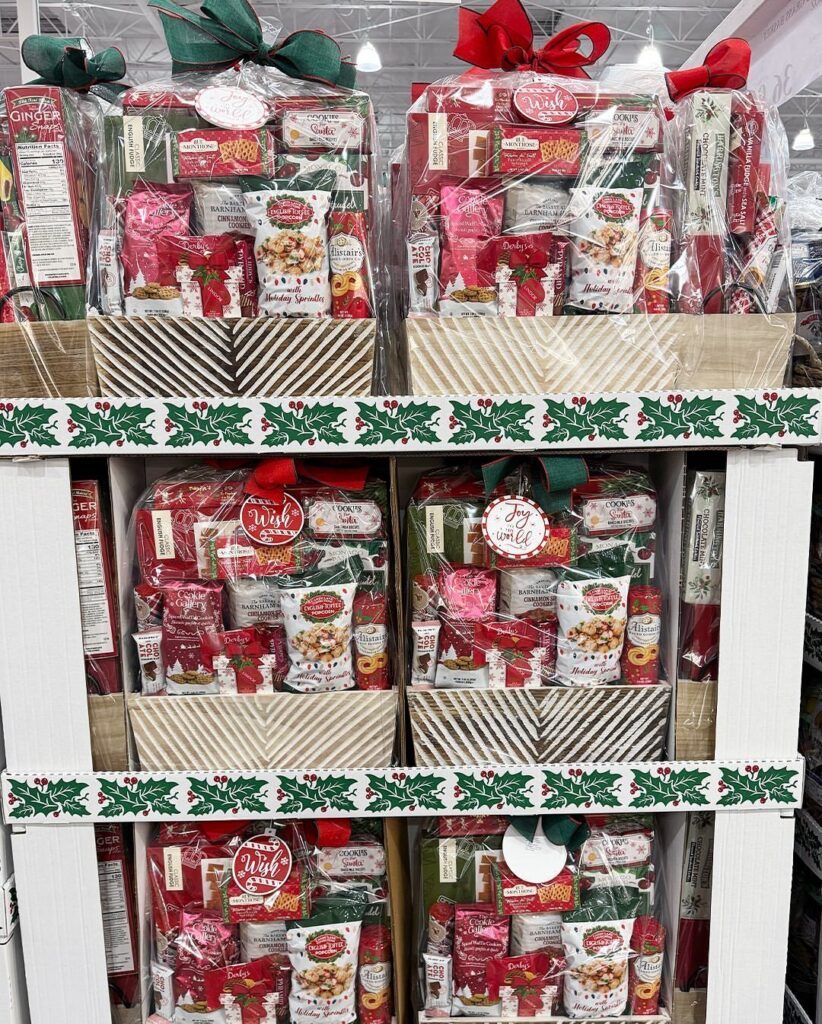Christmas gift baskets filled with red and white snacks wrapped in clear cellophane.