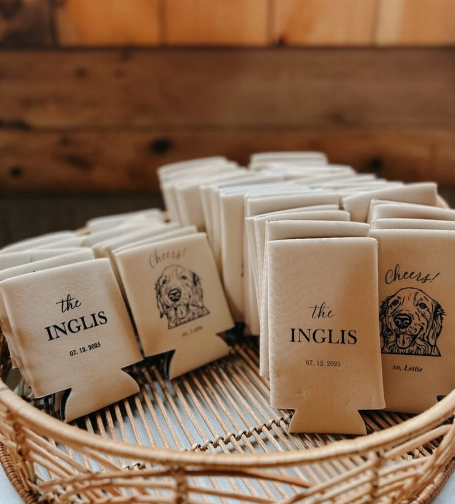 Beige neoprene beer cozies with dog illustrations and personalized text in a wicker basket.
