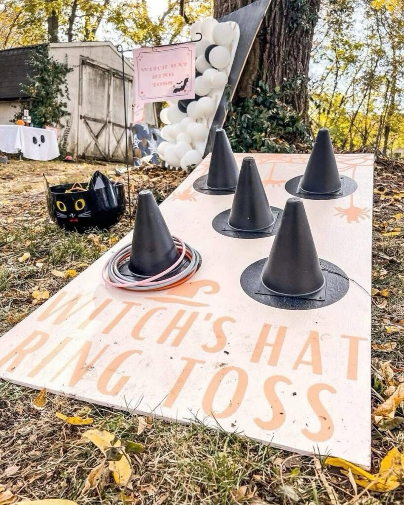Witch's Hat Ring Toss game with black cones and rings on a board.